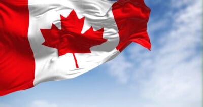 Canada national flag waving in wind on clear day